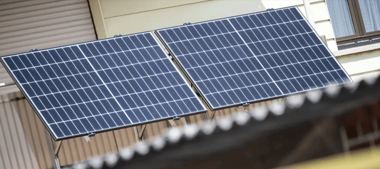 Two solar panels installed on a balcony for renewable energy generation.